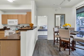 Open concept kitchen and dining area with bedroom view